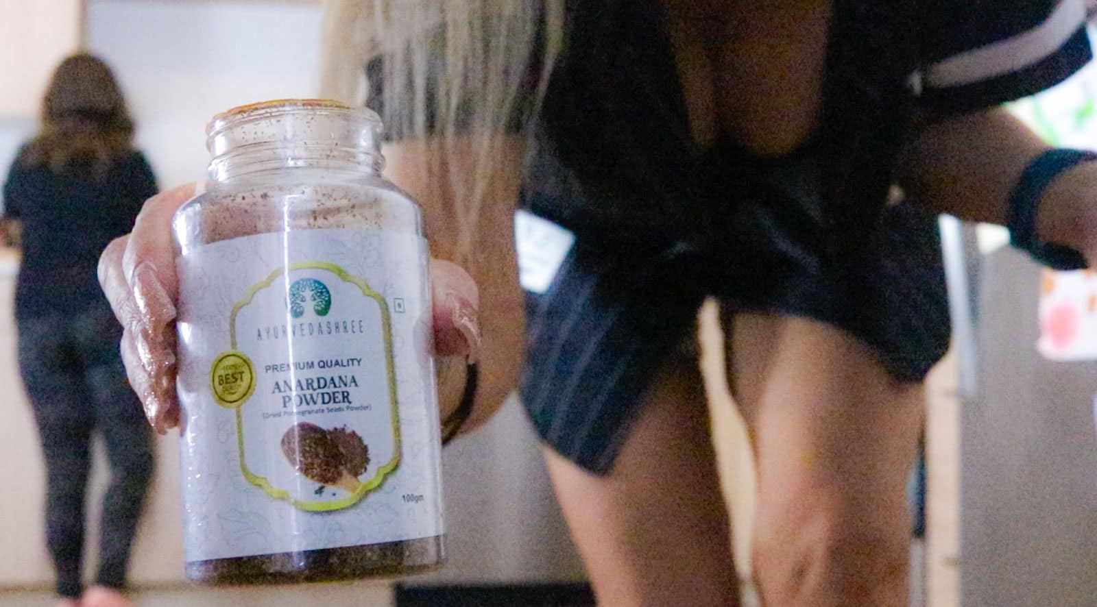 Kristin is holding anardana powder up to the camera