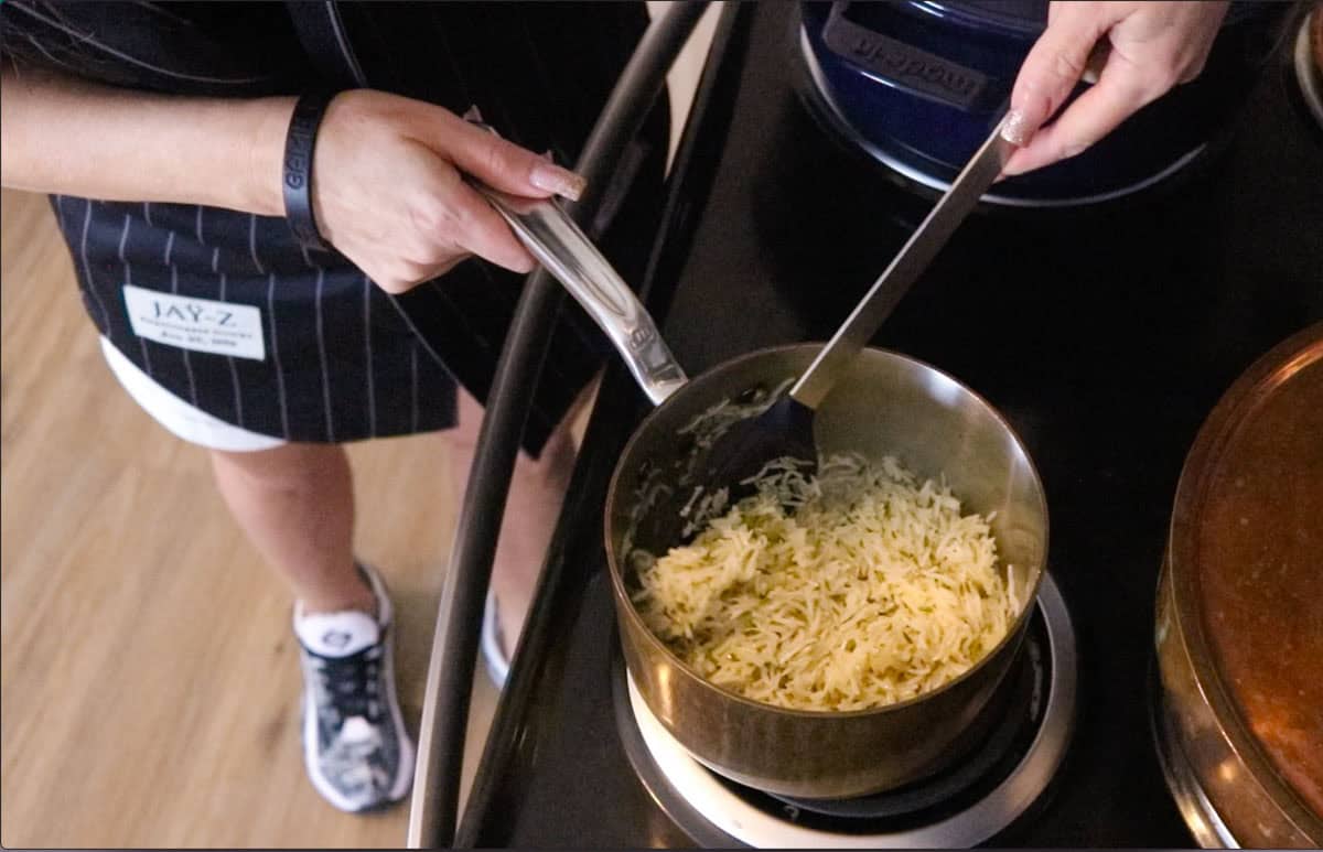 stirring cooked basmati rice in a small saucepan