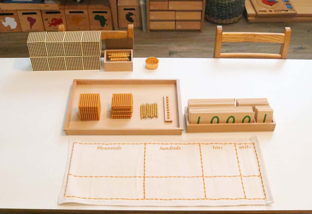 a Montessori tray of nines, numeral cards, and a place value mat