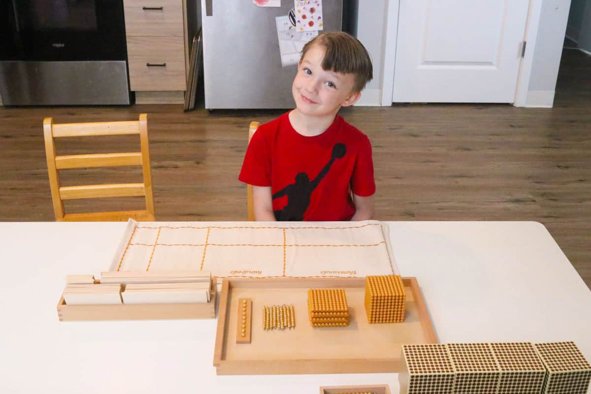 John is sitting in front of the Montessori Tray of Nines