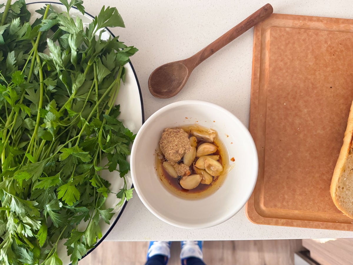 mustard, roasted garlic, and pan drippings in a bowl