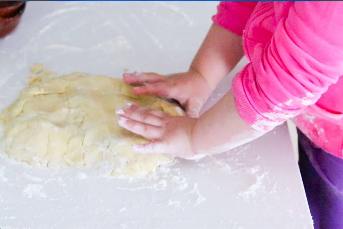Kat is shaping the dough into a rectangle