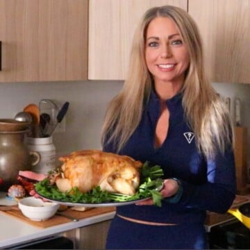 Kristin is holding a roasted garlic chicken