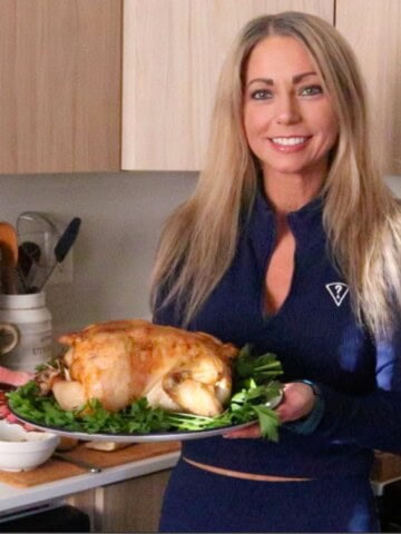 Kristin is holding a roasted garlic chicken
