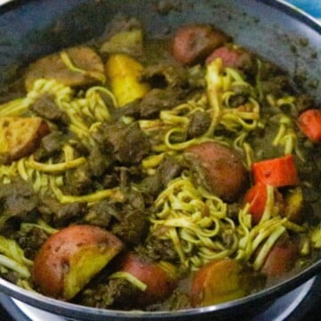 curry goat lo mein in a wok