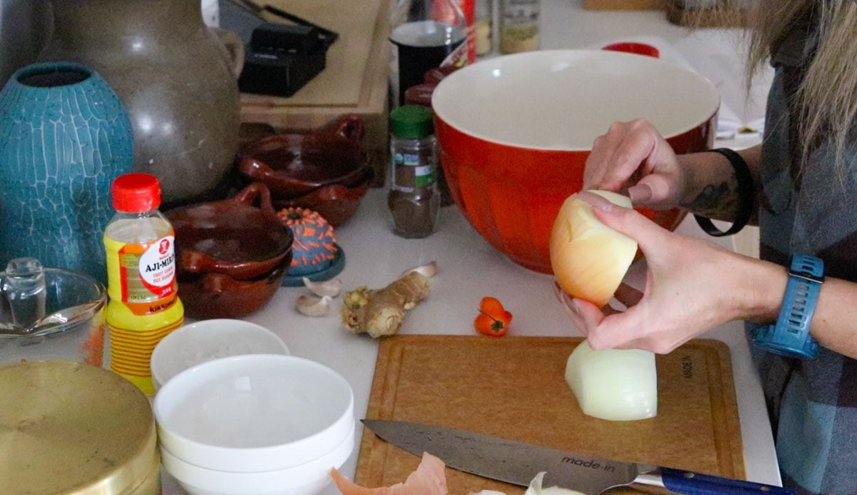 Kristin is peeling an onion