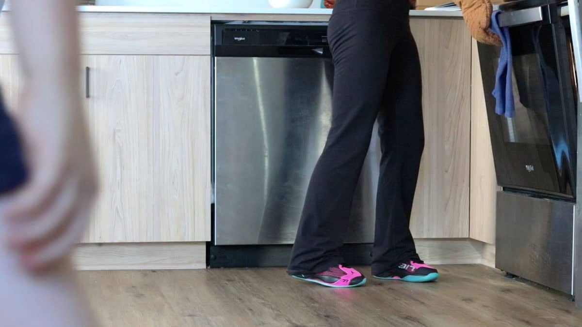 Kristin is closing the oven door