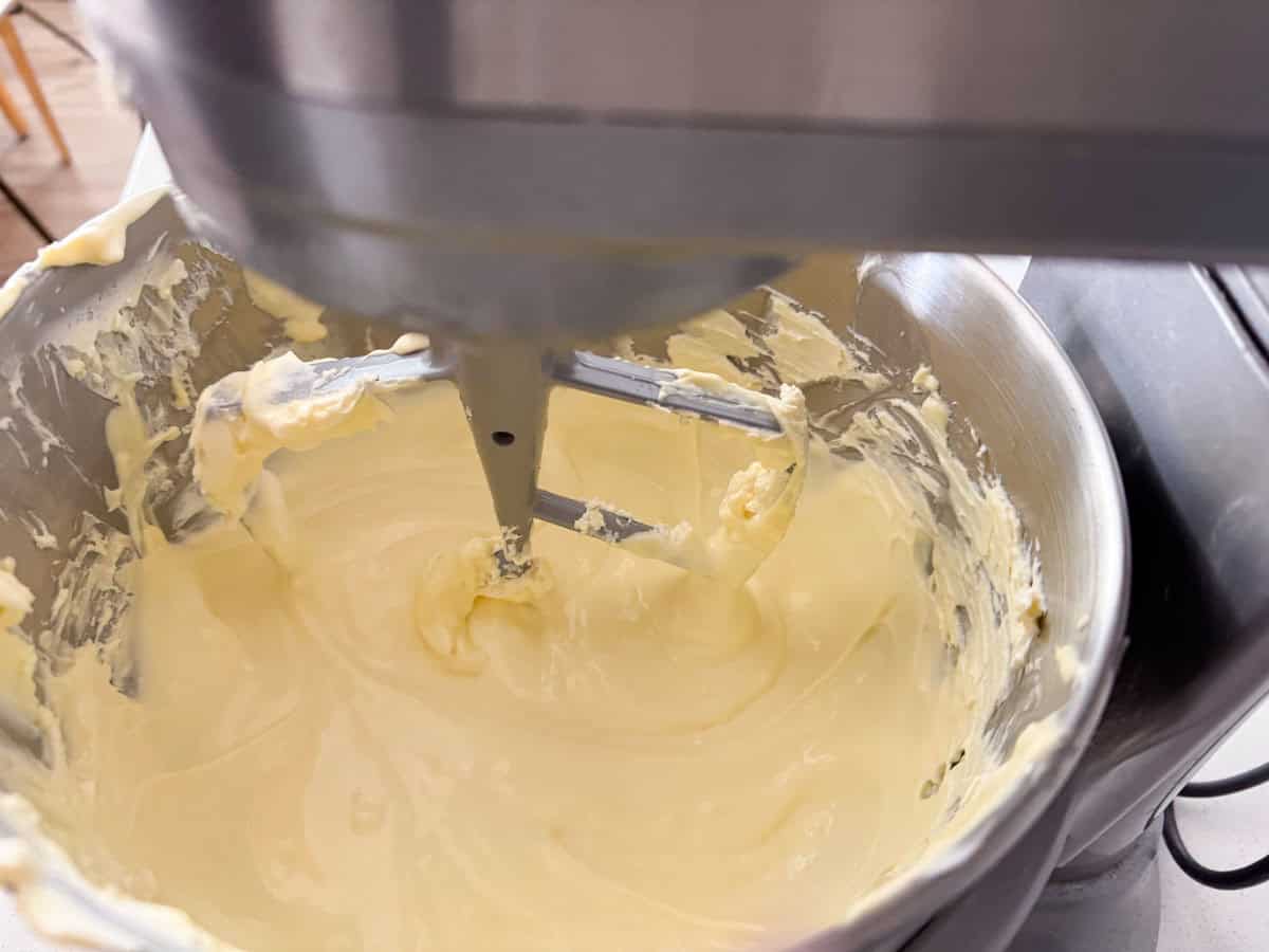cream cheese, butter, and eggs in a mixing bowl