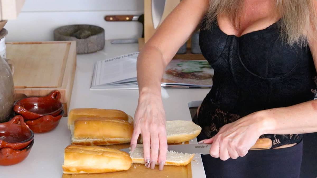 Kristin is prepping the hero by cutting out the interior crumb