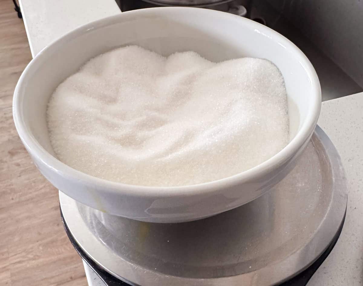 sugar in a bowl, on resting on a kitchen scale